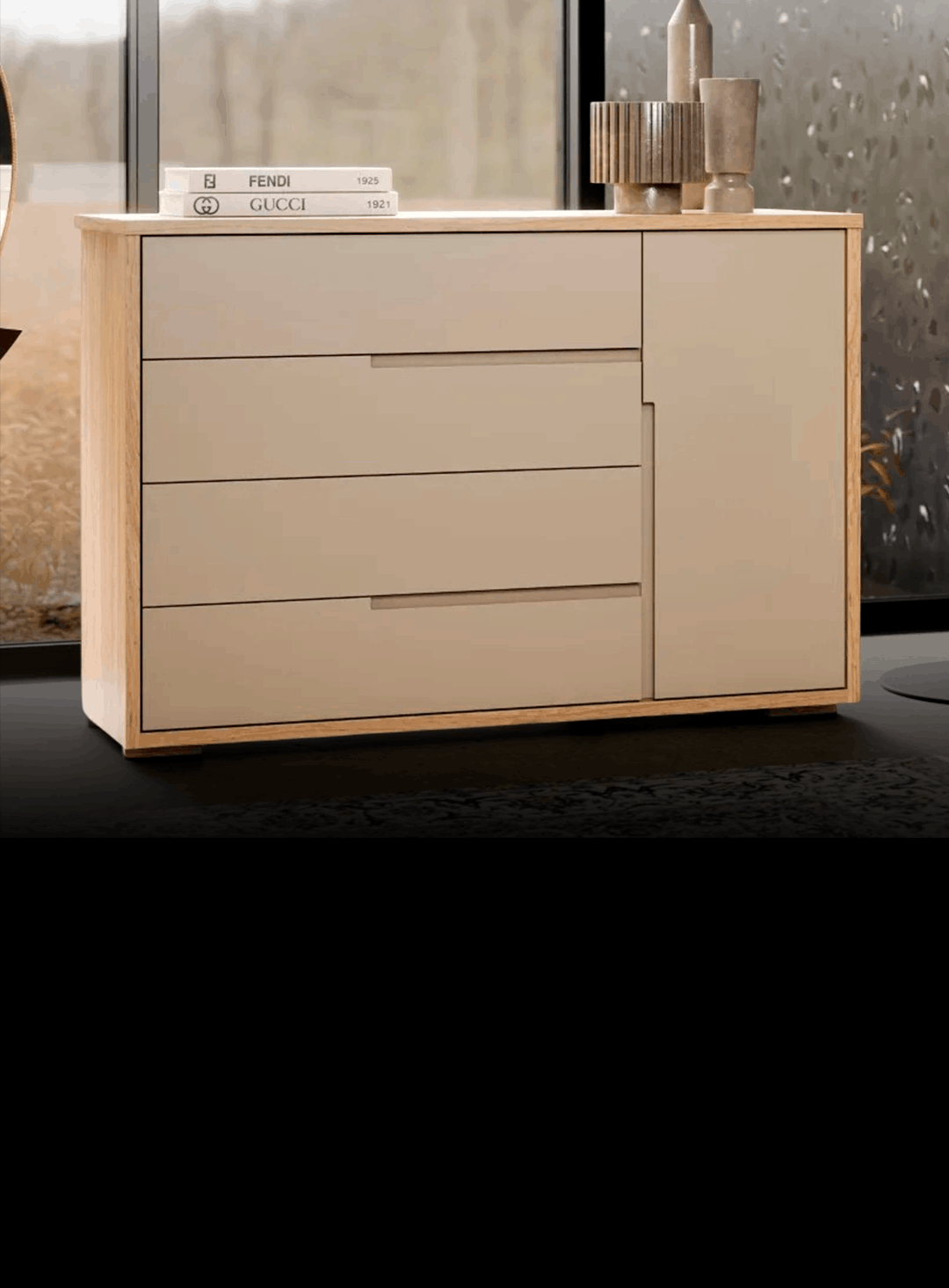 Beige modern dresser with four wide drawers on the left and a vertical cabinet on the right, topped with books and decorative wooden objects.
